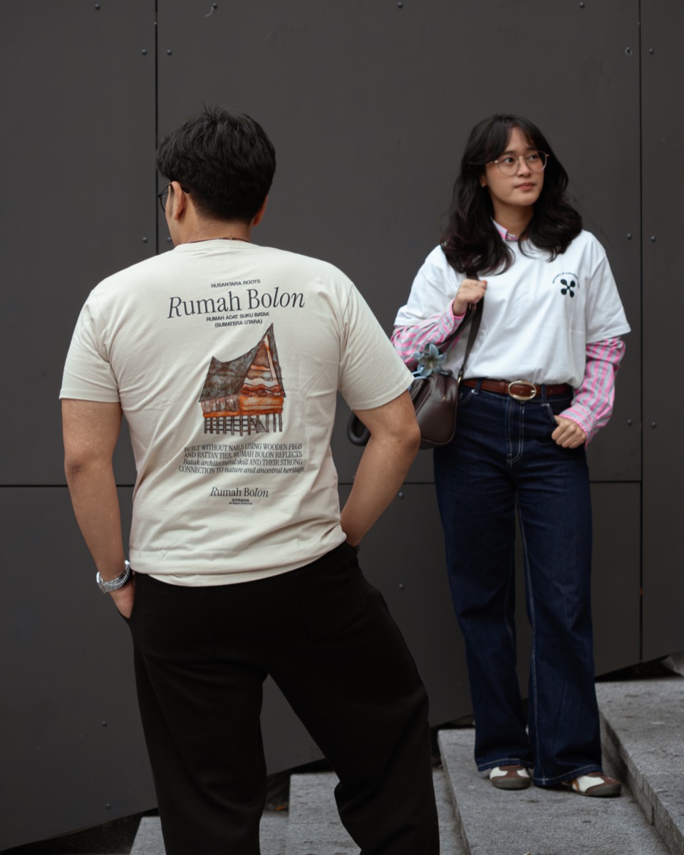 Model mengenakan koleksi kaos Frada